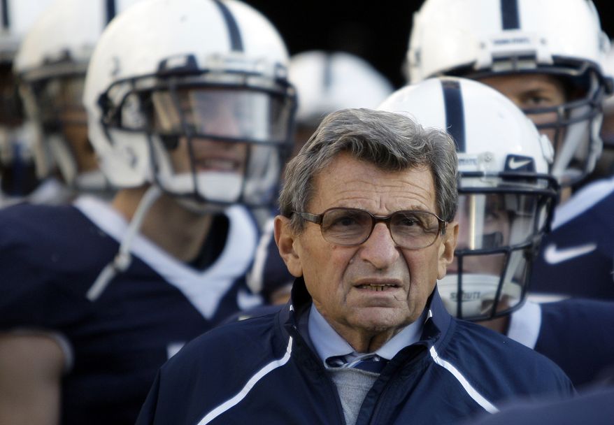 FILE - In this Nov. 7, 2009, file photo, Penn State Coach Joe Paterno stands with his players before taking the field for an NCAA college football game against Ohio State in State College, Pa. Paterno and other senior Penn State officials "concealed critical facts" about Jerry Sandusky's child abuse because they were worried about bad publicity, according to an internal investigation into the scandal released Thursday, July 12, 2012. (AP Photo/Carolyn Kaster, File)