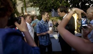 In this photo taken Thursday, July 12, 2012, freed Israeli soldier Gilad Schalit, center, speaks with the French Ambassador to Israel Christophe Bigot at the ambassador’s residence in Tel Aviv, Israel. (AP Photo/Ariel Schalit)

