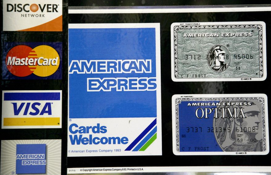 ** FILE ** This Sept. 5, 2007, file photo shows credit card decals on a store window in the Hollywood section of Los Angeles. Visa, MasterCard and major banks agreed to pay retailers at least $6 billion to settle a long-running lawsuit that alleged the card issuers conspired to fix the fees that stores pay to accept credit cards. (AP Photo/Nick Ut, File)