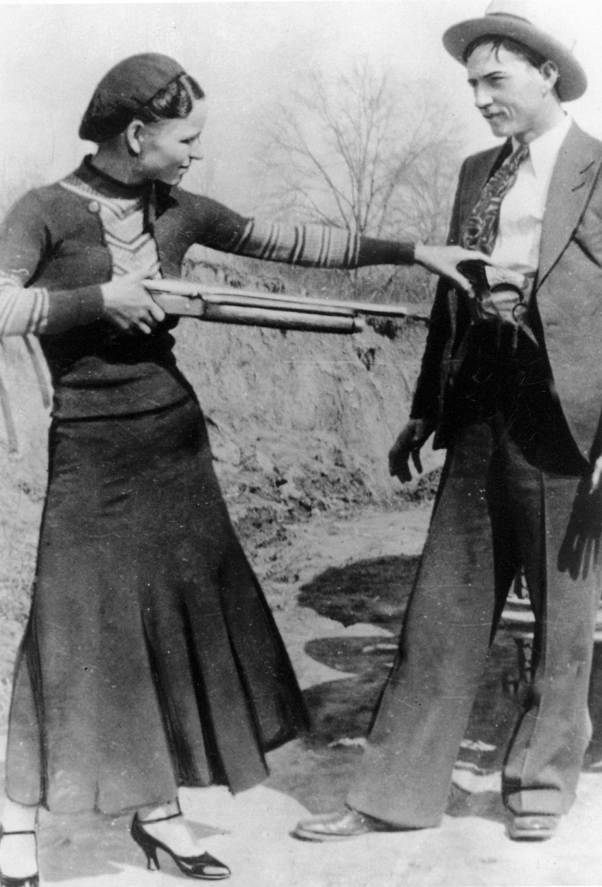 Bonnie Parker playfully holds a gun on boyfriend Clyde Barrow in an undated photo. Guns and personal items they carried on the day they were killed are being sold at auction. (Associated Press)