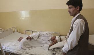An Afghan who was wounded in a suicide attack during wedding festivities lies in a hospital in Samangan province north of Kabul, Afghanistan, on Saturday, July 14, 2012. (AP Photo/Jawed Dehsabzi)

