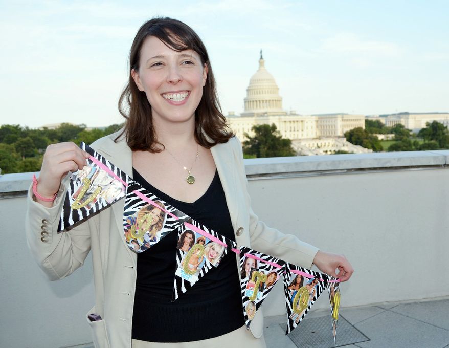 Holly Merbaum holds a kitschy, zebra-stripe sash with photos of celebs glued on after winning the Celebrity Wonks & Wonkettes league in Washington, D.C. Now, celeb watchers have a handful of their own websites to draft “teams” and trash talk their friends. (Associated Press)