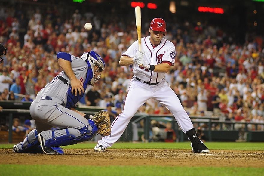 Mets' catcher Josh Thole fails to control a wild pitch from Pedro Beato (not pictured) while Tyler Moore bats in the bottom of the tenth inning during the Washington Nationals game against the New York Mets at Nationals Park, Washington D.C.,Tuesday, July 17, 2012. The wild pitch allowed Ryan Zimmerman to score from third base to win the game for the Nationals 5-4. (Ryan M.L. Young/The Washington Times)