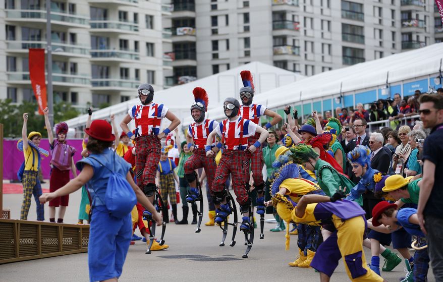 Members of the National Youth Theatre perform during the Olympic Team Welcome Ceremony at the Olympic Village for the 2012 Summer Olympics, Tuesday, July 17, 2012, in London. Opening Ceremonies for the London Olympics will be held Friday July 27, 2012. (AP Photo/Jae C. Hong)