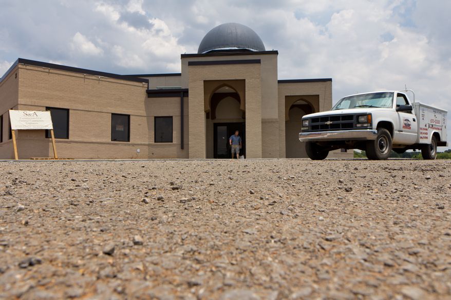 FILE - In a Thursday, June 21, 2012 file photo, a worker walks out of the construction site of a mosque being built in Murfreesboro, Tenn. The Islamic Center of Murfreesboro and its religious leader, Imam Ossama Bahloul, sued Rutherford County on Wednesday, July 18, 2012 and asked the federal court for an emergency order to let worshippers into the building before the holy month of Ramadan starts at sundown on Thursday. In May, a Rutherford County judge overturned the county's approval of the mosque construction and this month he ordered the county not to issue an occupancy permit for the 12,000-square-foot building. (AP Photo/Erik Schelzig, File)