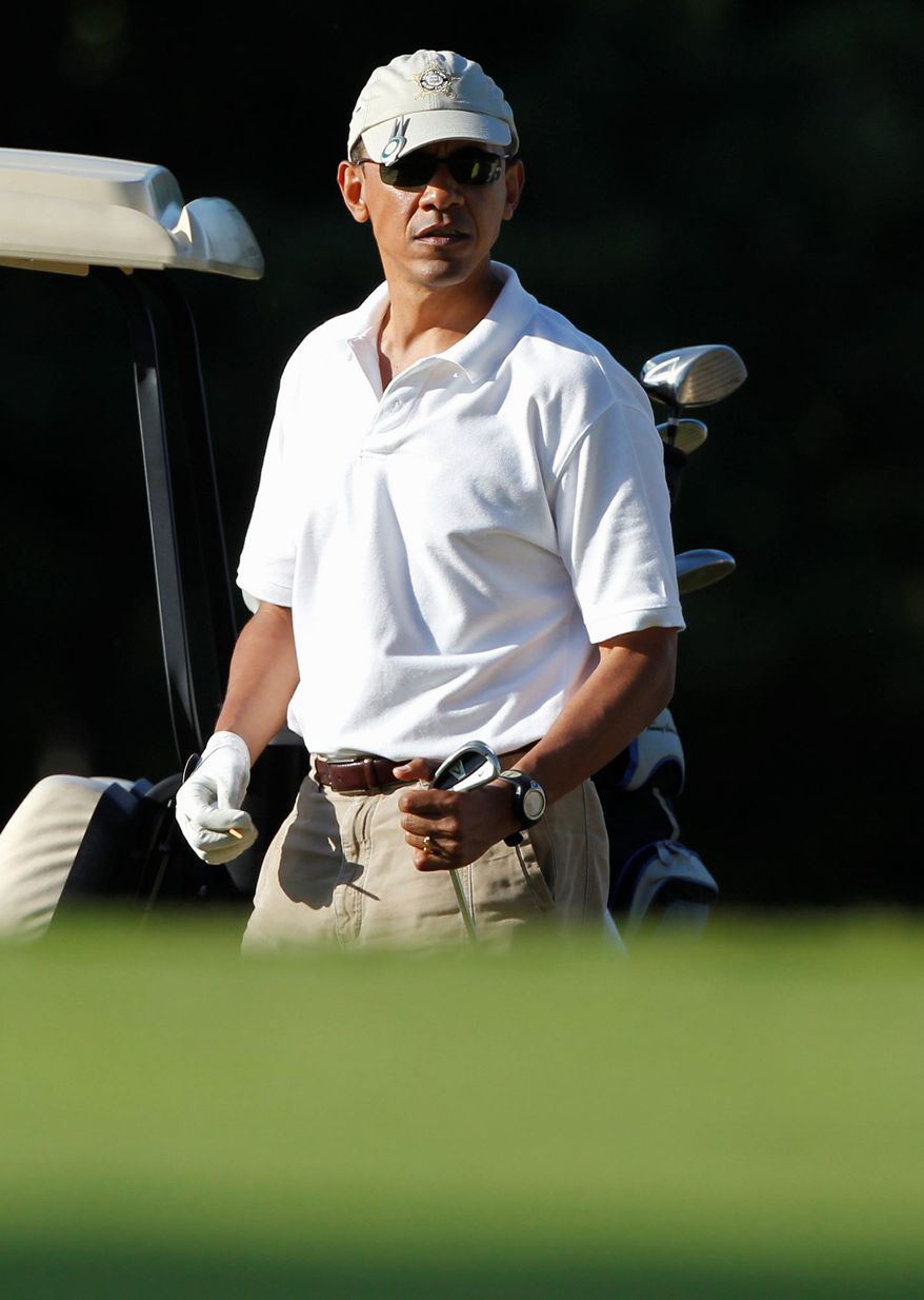 President Obama prepares to tee off while playing golf at Mink Meadows Golf Club on the island of Martha’s Vineyard, Mass., in August 2011. (Associated Press)