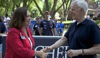 Nebraska state Sen. Deb Fischer (left), a candidate for Republican senate, meets Democratic Senate candidate Bob Kerrey at a Fourth of July parade in Omaha, Neb. Fischer is running against Kerrey for the senate seat vacated by Democrat Ben Nelson. (Associated Press)