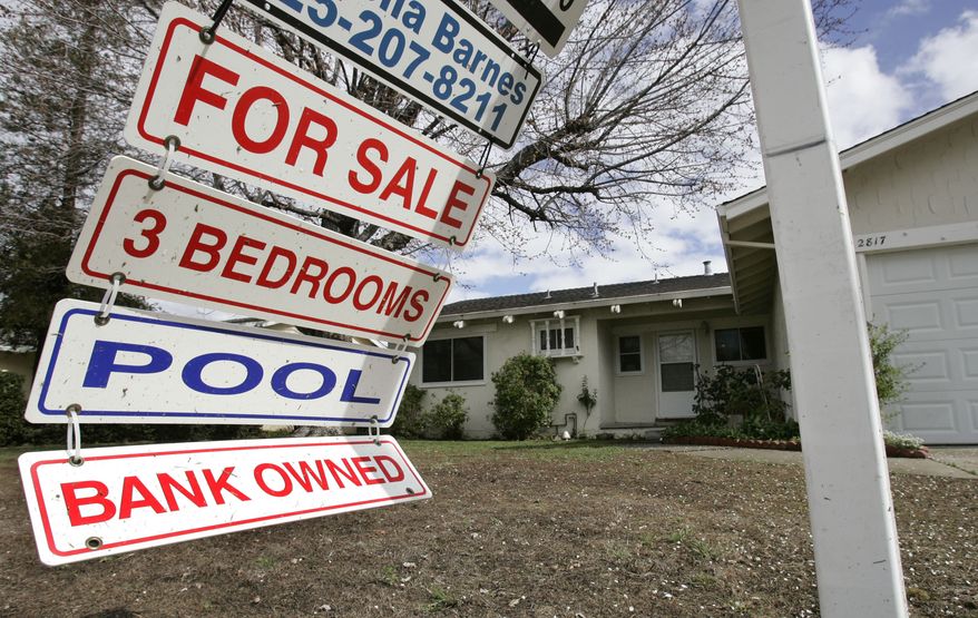 **FILE** A foreclosure sign blows Feb. 23, 2009, in the wind in front of a home under foreclosure in Antioch, Calif. (Associated Press)