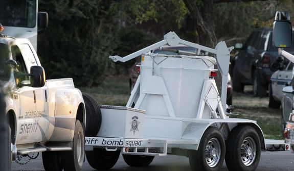A bomb disposal vehicle arrives July 21, 2012, near the Aurora , Colo., apartment of  James Holmes, the alleged gunman in an assault at a movie theater that left 12 dead and more than three dozen people injured. (Associated Press)