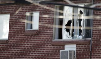 Windows are broken July 20, 2012, at the Aurora, Colo., apartment of James Holmes, 24, the alleged gunman in an assault at a theater during a midnight premiere of &quot;The Dark Knight.&quot; Twelve died and more than three dozen people were shot in the assault. (Associated Press)