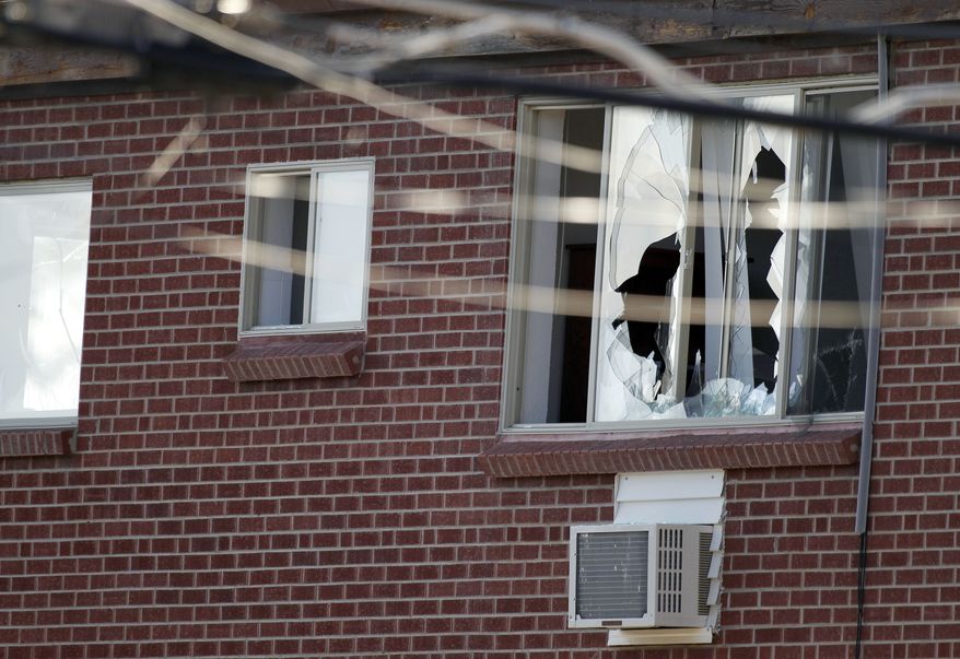 Windows are broken July 20, 2012, at the Aurora, Colo., apartment of James Holmes, 24, the alleged gunman in an assault at a theater during a midnight premiere of "The Dark Knight." Twelve died and more than three dozen people were shot in the assault. (Associated Press)