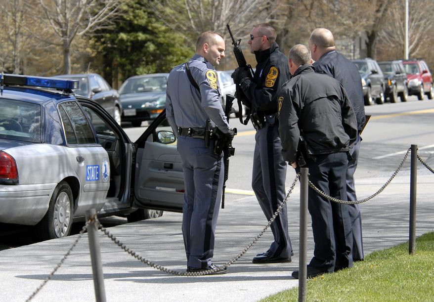 **FILE** State and local police wait April 16, 2007, for a building to be cleared by police on the Virginia Tech campus in Blacksburg, Va., following a shooting incident. (Associated Press)