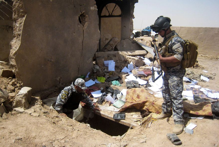 ** FILE ** In this Tuesday, April 20, 2010, file photo, Iraqi policemen search the site of a joint U.S-Iraqi raid that killed Abu Omar al-Baghdadi and Abu Ayyub al-Masri, two top-ranking al Qaeda figures, about six miles (10 kilometers) southwest of Tikrit. The first online statement from the new leader of al Qaeda&#39;s affiliate in Iraq claims that the militant network is returning to the old strongholds from which it was driven by U.S. forces and their Sunni allies prior to the American withdrawal at the end of last year, and that it is preparing operations to free prisoners and assassinate court officials. (AP Photo, File)

