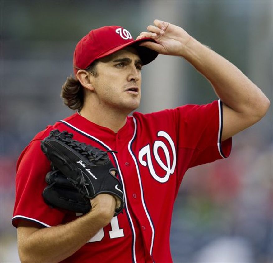Washington Nationals starting pitcher John Lannan pauses in the first inning during the second baseball game of a doubleheader against the Atlanta Braves, Saturday, July 21, 2012. Lannan gave up two runs in the first inning but none in the next six in a game the Nationals went on to win 5-2. (AP Photo/Carolyn Kaster)