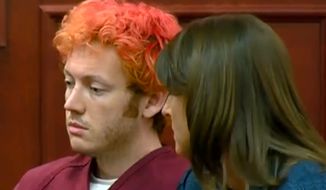 In this image taken from video provided by KUSA.com, James Holmes, left, the suspected gunman in Friday&#x27;s Colorado theater massacre, makes his first appearance in court with his attorney Tamara Brady in Centennial, Colo., on Monday, July 23, 2012. (AP Photo/KUSA.com)