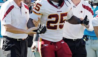 Washington Redskins&#39; Tim Hightower (25) is helped from the field after being injured during the third quarter of an NFL football game against the Carolina Panthers in Charlotte, N.C., Sunday, Oct. 23, 2011. (AP Photo/Bob Leverone)
