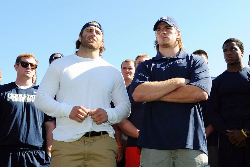 Penn State senior running back Michael Zordich, left, and senior linebacker Michael Mauti, right, give a statement in support of their team, as other players look on, Wednesday, July 25, 2012 in State College, Pa. (AP Photo/The Centre Daily Times, Nabil K. Mark) MAGS OUT MANDATORY CREDIT
