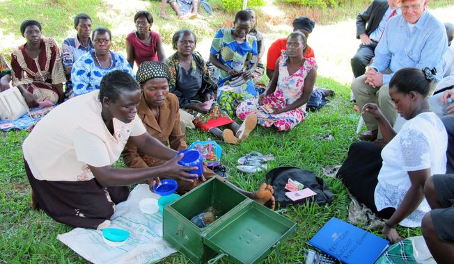 Women affected by AIDS share stories of survival at the Reach Out clinic near Kampala, Uganda, which receives funding from a U.S.-backed program. Research suggests stemming the spread of the AIDS virus may be possible, even in some of the world’s poorest countries. (Associated Press)