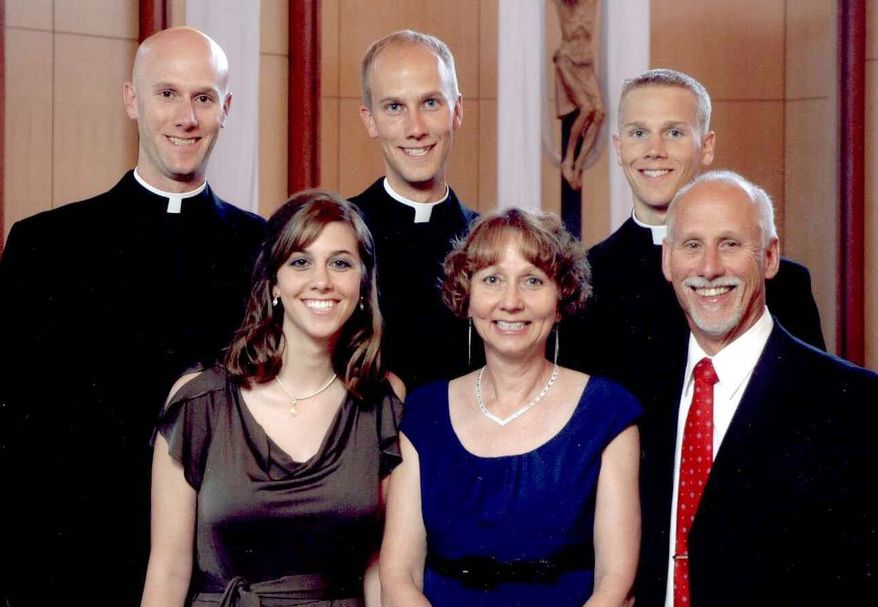 A family portrait shows (back from left) Vincent Strand, Luke Strand and Jacob Strand, and (front from left) Theresa Krausert, Bernadette Strand and Jerry Strand in Dousman, Wis., in 2009. The Strand brothers, ranging from 26 to 31, said they all felt their calling to serve the church independently, with no pressure from their parents, at a time when fewer men are going into the clergy. (Associated Press)