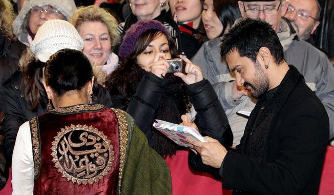 associated press photographs

Bollywood star Aamir Kahn, signing autographs at the opening of the Berlin film festival, has taken TV by storm in his native India with a talk show. “I want to do something dynamically different,” he says. “I continued to think about it, and slowly this idea was conceived.” The idea turned out to be “Truth Alone Prevails,” a show that focuses on topics once thought to be off-limits in the country of 1.2 billion people.