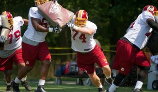 Tyler Polumbus (74), signed by the Redskins during last season, took snaps with the first team Thursday. Maurice Hurt and Willie Smith also are in the mix for playing time with starter Jammal Brown sidelined by a hip injury. (Andrew Harnik/The Washington Times)