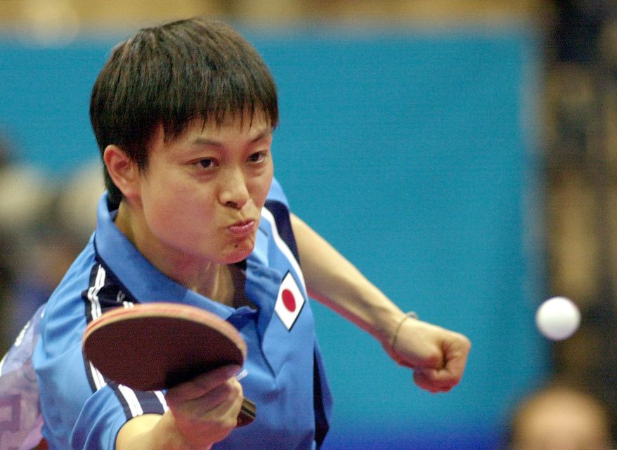 Japan's Chire Koyama returns a shot in her women's singles quarterfinals table tennis match Friday, Sept. 22, 2000 in Sydney. Koyama beat China's Wang Nan 21-19. 21-8, 22-20. (AP Photo/Elaine Thompson)