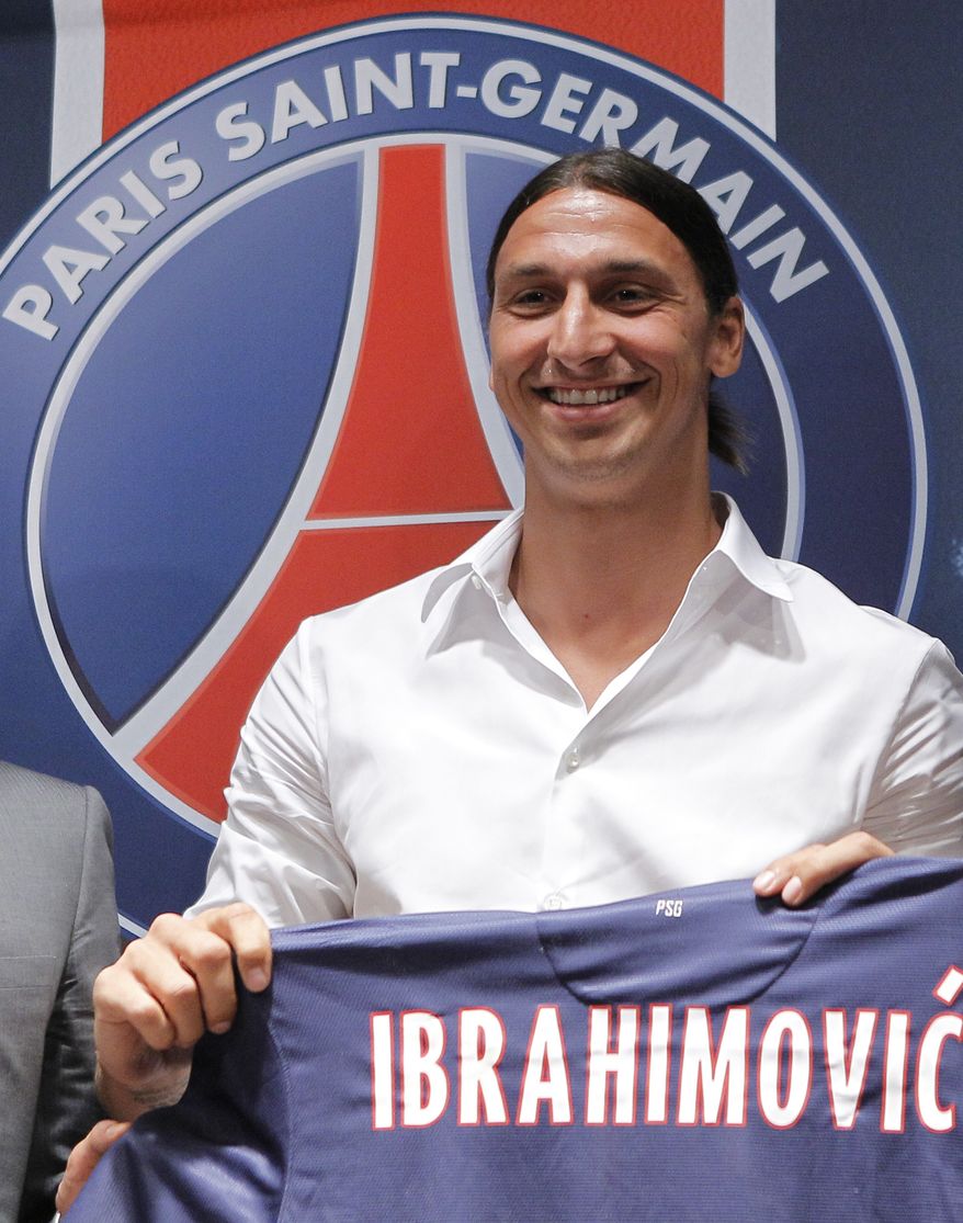 New PSG striker Zlatan Ibrahimovic, of Sweden, holds his jersey during a press conference at the Parc des Princes stadium in Paris, Wednesday, July 18, 2012 after signing an agreement with the Paris Saint Germain (PSG) club. Ibrahimovic will be the Ligue 1 club's third major signing of the summer, following the arrivals of former AC Milan teammate Thiago Silva and Napoli's Ezequiel Lavezzi. (AP Photo/Jacques Brinon)
