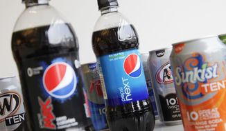 **FILE** Bottles of Pepsi Next and Pepsi Max are displayed among cans of 10-calorie sodas from PepsiCo., on  June 11, 2012, in New York. (Associated Press)