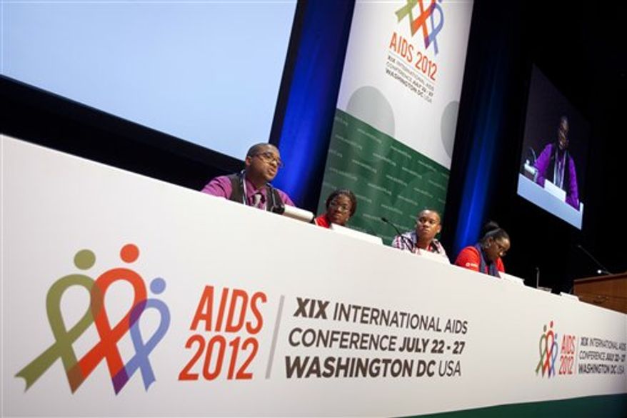 **FILE** Lawrence Stallworth II (left), 20, of Cleveland, who was diagnosed with HIV at age 17, speaks July 22, 2012, on a youth panel at the International AIDS Conference in Washington. Stallworth learned he was infected with HIV at age 17, when he was a high-school senior, after a hospitalization. A black gay man, he's among one of the nation's highest-risk groups. (Associated Press)