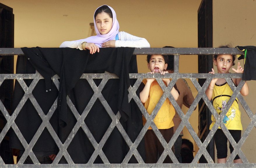 Syrian refugees arrive July 26, 2012, at the border crossing by the Iraqi town of Qaim, 200 miles (320 kilometers) west of Baghdad. (Associated Press)