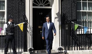 Republican presidential candidate Mitt Romney walks out of 10 Downing Street in London after meeting with British Prime Minister David Cameron on Thursday, July 26, 2012. (Associated Press)