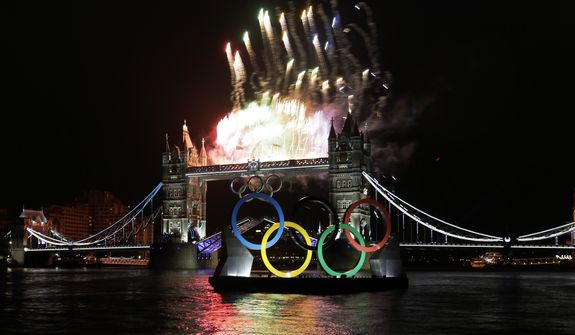 Fireworks and Olympic rings light up at Tower Bridge during the Opening Ceremony at the 2012 Summer Olympics, Friday, July 27, 2012, in London. (AP Photo/Kirsty Wigglesworth)