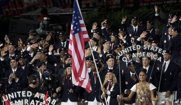 Fencer Mariel Zagunis leads Team USA into the stadium during the Opening Ceremony for the 2012 Olympic Summer Games, Friday, July 27, 2012, in London. (AP Photo/The Canadian Press, Sean Kilpatrick)
