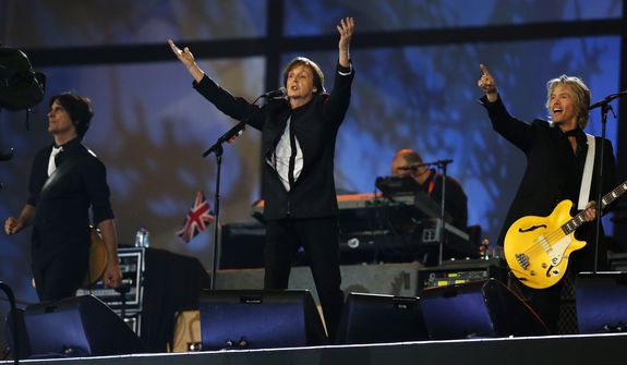 Paul McCartney, center, performs during the Opening Ceremony at  the 2012 Summer Olympics, Saturday, July 28, 2012, in London. (AP Photo/Matt Dunham, Pool)