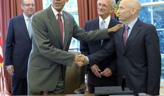 President Obama shakes hands July 27, 2012, with AIPAC chairman Lee Rosenberg in the Oval Office of the White House after signing the U.S.-Israel Enhanced Security Cooperation Act. Also present are Howard Friedman (left), former AIPAC chairman, and Rep. Howard Berman (second from right), California Democrat. (Associated Press)
