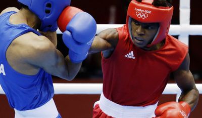 Andrique Allisop of the Seychelles, right, connects with India&#39;s Bhagwan Jai, during men&#39;s light 60-kg boxing at the 2012 Summer Olympics, Sunday, July 29, 2012, in London.  (AP Photo/Patrick Semansky)