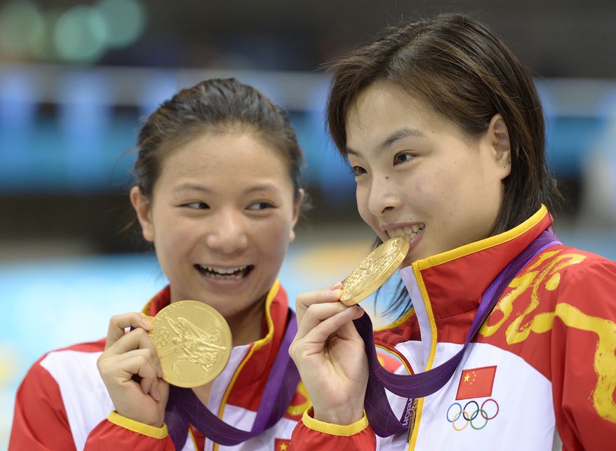 London 2012 diving: Gold medalists He Zi, left, and Wu Minxia, right, pose with their medals after the 3 Meter Synchronized Springboard final at the Aquatics Centre in the Olympic Park on Sunday, July 29, 2012. (AP Photo/Mark J. Terrill)