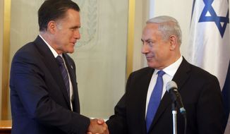 Israeli Prime Minister Benjamin Netanyahu (right) and Republican presidential candidate Mitt Romney shake hands July 29, 2012, at Netanyahu&#39;s office in Jerusalem. (Associated Press)