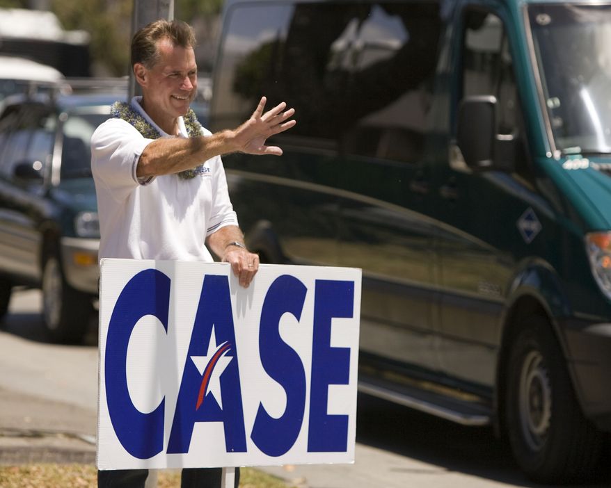 **FILE** Former Hawaii Rep. Ed Case holds a sign May 22, 2010, as he campaigns in Honolulu. (Associated Press)