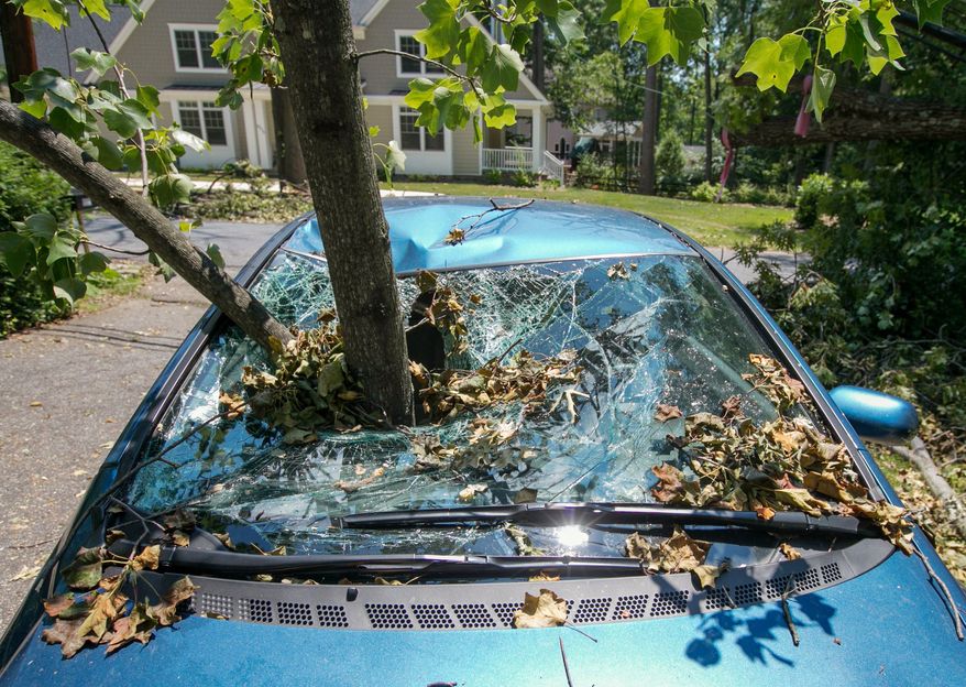 A branch remains impaled in a car in Bethesda three days after the June 29 derecho. More thunderstorms since then have brought down even more trees. (Andrew S. Geraci/The Washington Times)