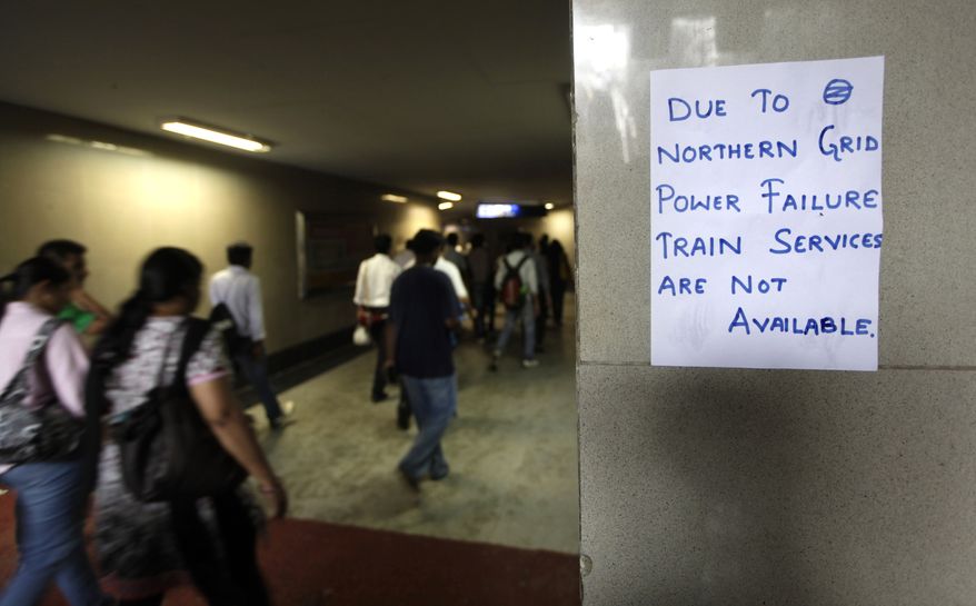 A handwritten notice about power failure is pasted outside a Metro station in New Delhi on July 31, 2012, after Delhi Metro rail services were disrupted following power outages. (Associated Press)