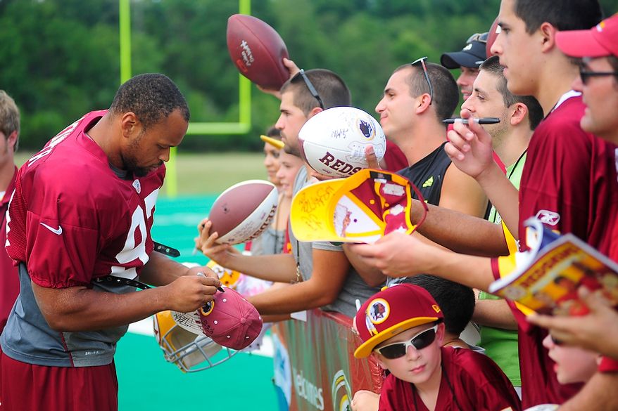 Lorenzo Alexander (#97) signs autographs for fans during Redskins' training camp at Redskins Park, Ashburn, Va., Monday, July 30, 2012. (Ryan M.L. Young/The Washington Times)