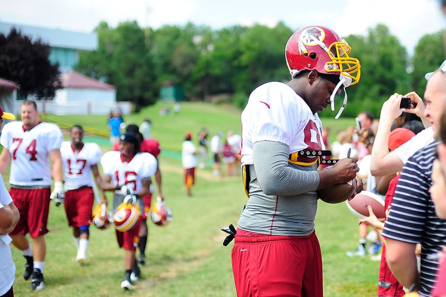 Beau Reliford signs autographs for fans during Redskins' training camp at Redskins Park, Ashburn, Va., Monday, July 30, 2012. (Ryan M.L. Young/The Washington Times)