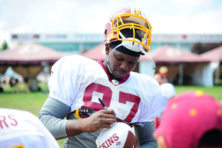 Beau Reliford signs autographs for fans during Redskins' training camp at Redskins Park, Ashburn, Va., Monday, July 30, 2012. (Ryan M.L. Young/The Washington Times)