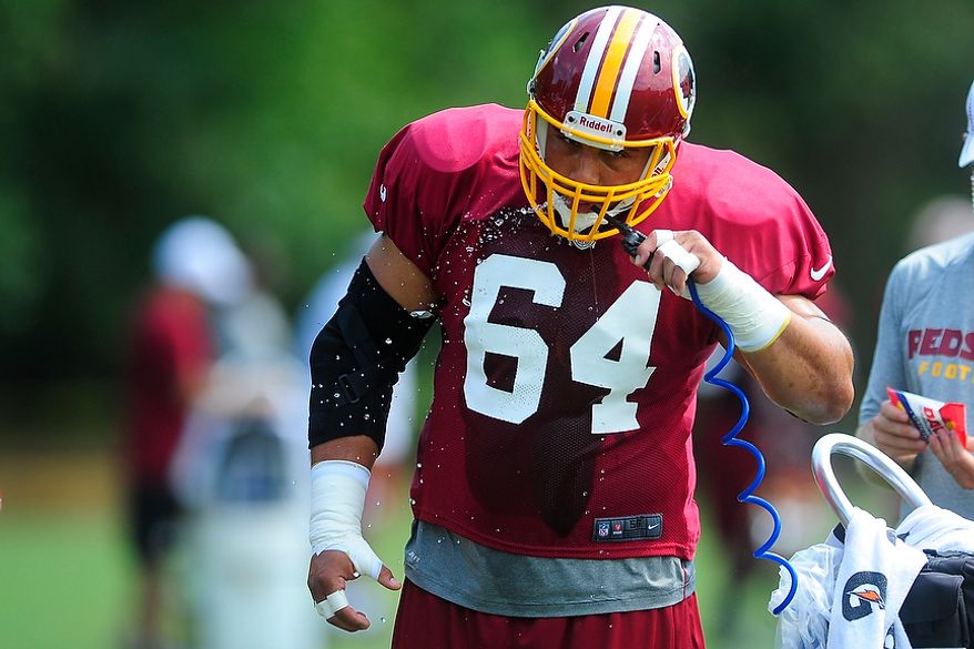 Kedric Golston (#64) takes a break for water during Redskins' training camp at Redskins Park, Ashburn, Va., Monday, July 30, 2012. (Ryan M.L. Young/The Washington Times)