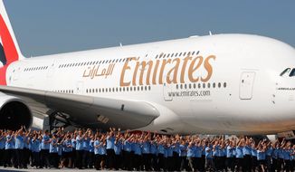 Workers of Airbus accompany the first Airbus A380 plane for the Emirates airline during a ceremony at the German Airbus plant in Hamburg Finkenwerder in June 2008. The Gulf’s three big airlines are all increasingly forging cross-border partnerships to extend their reach deeper into international markets. (Associated Press)