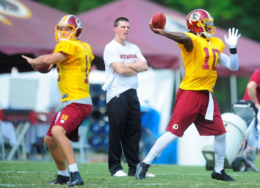 Ryan M.L. Young/The Washington Times
Redskins rookie quarterbacks Robert Griffin III (right) and Kirk Cousins honed their skills during drills this week.
