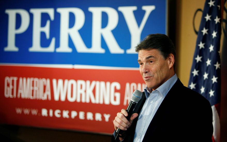 Republican presidential hopeful, Texas Gov. Rick Perry, speaks to local residents during a campaign stop at the Pizza Ranch restaurant, Monday, Dec. 19, 2011, in Manchester, Iowa. (AP Photo/Charlie Neibergall)