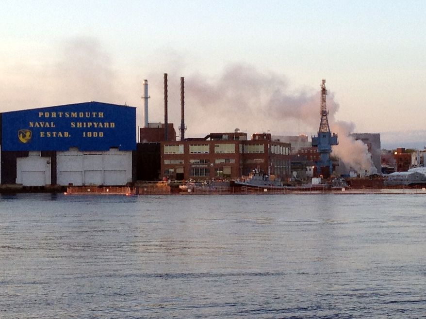 **FILE** A fire burns May 23, 2012, on a nuclear submarine at the Portsmouth Naval Shipyard in Kittery, Maine. A civilian employee working as a painter and sandblaster aboard the submarine has been charged with setting the fire, which caused $400 million in damages to the vessel. (Associated Press/WMUR, Jean Mackin)