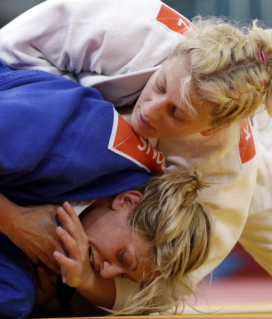 Kayla Harrison of the United States (in white) competes Aug. 2, 2012, against Gemma Gibbons of Great Britain for the gold medal during the women's 78-kg judo competition at the 2012 Summer Olympics in London. (Associated Press)
